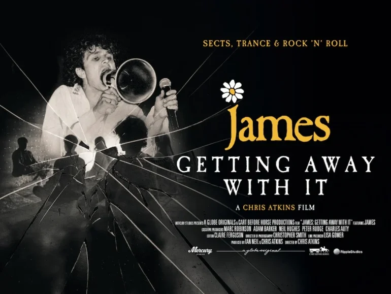 Poster for the film James: Getting Away With It, showing a male singer with a microphone and a cracked-glass motif, with the title in bold white lettering and a daisy graphic above 'James'.
